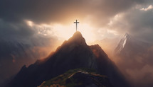 A cross on top of a mountain during a sunset