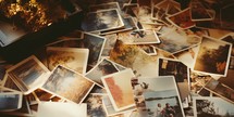 Vintage polaroids spread out on a table. 