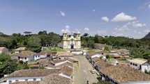 Drone flies backwards from Igreja de Santo Antonio over entire city of Tiradentes in Minas Gerais, Brazil