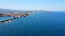 Aerial shot drone flies right while camera pans left over port in Chania, Crete, Greece