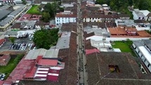 Aerial shot drone camera angled 60 degrees down as it flies over main street in Salento