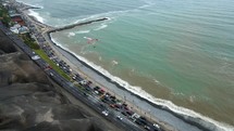 Paraglider flying over coastal highway