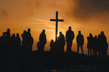 Silhouettes of a group of people with a cross in the background at sunset