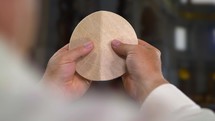 Pope Francis breaking altar bread.