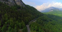 Swiss Alps Aerial Jib Crane Shot Drone Alps Rugged Mountians Push In Countryside Outback Landscape Cliff Evergreen Trees Interlaken Switzerland