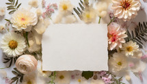 flat lay floral with blank deckle edge watercolor paper in the center
