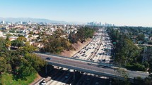 Aerial Los Angeles Freeway Traffic Jib Shot Rising Driving California City Drone