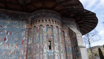 Slide Shot of blue Painted Wall Of Orthodox Church - Voronet Monastery In Woronet, Romania. 