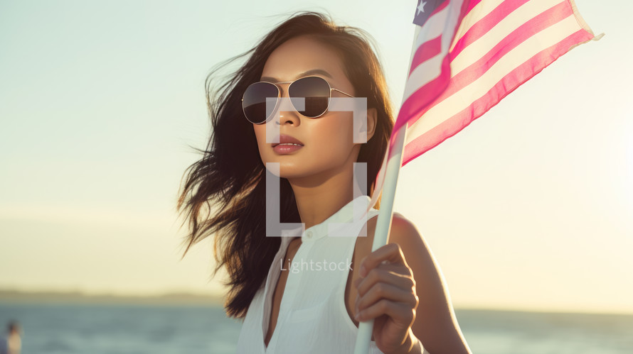 AI generated image. Asian woman in sunglasses holding US flag at the ocean. USA Independence Day concept