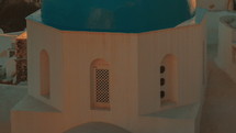 Establishing Close-up Shot of a Traditional Blue Dome Cycladic Church and the Aegean Sea