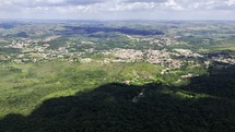 Drone flies to the left high over Serra do Sao Jose looking down at Tiradentes, Brazil 