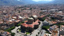 Aerial shot drone hovers over Teatro Massimo with birds flying around in Palermo, Sicily, Italy