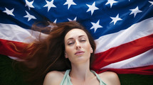AI generated image. Young woman lying down on US flag outdoors on a green grass. USA Independence Day concept