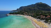 Aerial shot drone flies to the left orbiting the south side of Mondello Beach in Palermo, Sicily, Italy