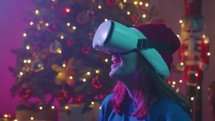 Girl talking with vr virtual reality headset in Christmas room