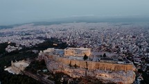 Aerial 4K Drone Shot Over Athens Acropolis And Odeon Of Herodes In Evening