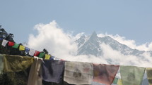 Tibetan prayer flags blowing in wind with Himalaya Mountains in background