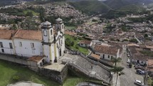 Drone slowly orbits right in front of Church of Santa Efigenia in Ouro Preto, Brazil