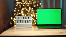 Black Friday computer on the table with green screen