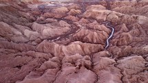 Aerial shot drone flies to left over river flowing through Death Valley in Atacama Desert at sunset