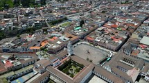 Aerial shot drone flying forward over popular city sights in Quito with camera slighted tilted down