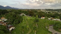 Drone flies backwards from Church of St. Francisco de Paula over the city of Tiradentes past Igreja de Santo Antonio