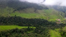 Aerial shot drone flies forward in wide shot of Cocora Valley on a cloudy morning