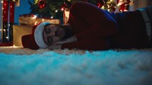 Man Sleeps By Christmas Gift Box wait for the santa's gift box