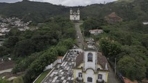 Drone flies low over Igreja de Sao Jose and up the hill to Church of Saint Francis of Paola