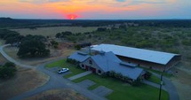 Aerial Texas Ranch Sunset Horse Arena Barn Paddock Field Drone 4K
