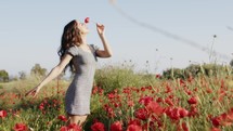 Beautiful Girl Has Fun in Nature Alone with Flowers in Summer