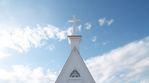 White classic church steeple with blue sky background