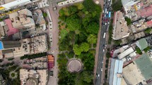 Aerial shot drone flies forward with camera straight down east over central park in downtown area with skyscrapers