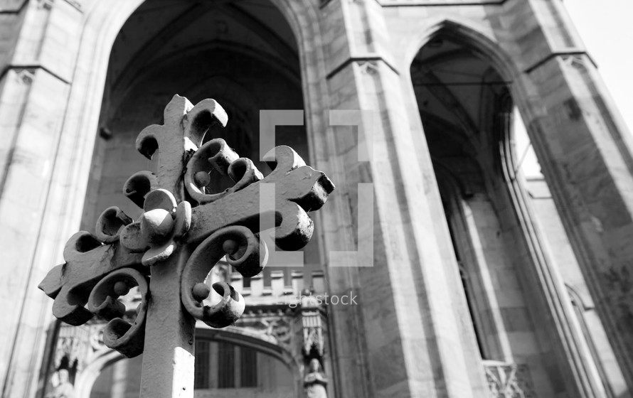 cross in front of a cathedral
