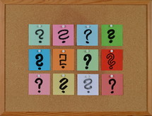 questions on a cork board 