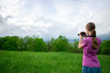 a girl holding a camera taking pictures 