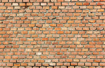 Full frame detailed background of a weathered red brick wall, ideal for texture and patterns