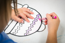 a child coloring with crayons 