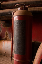 Vintage fire extinguisher on a red truck