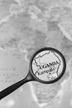magnifying glass over a map of Uganda 