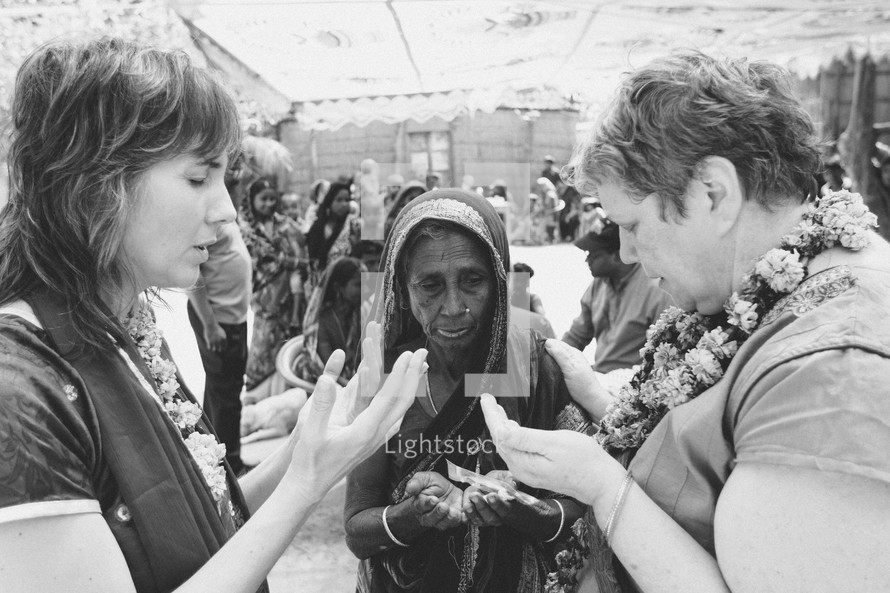 Women in prayer on a mission trip 