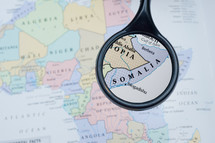 magnifying glass over a map of Somalia 