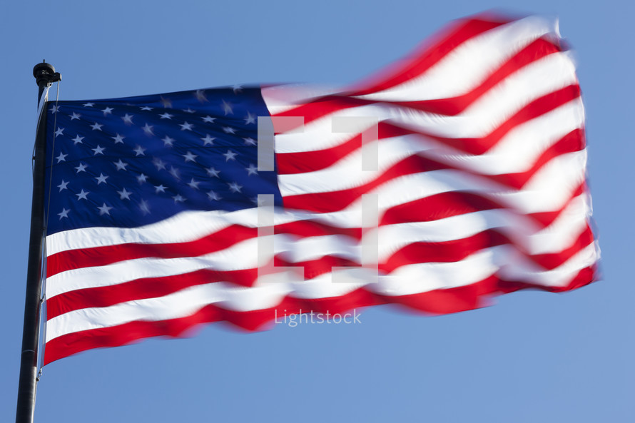 The Flag of the USA waving in the wind. New York City, New York, USA. 
