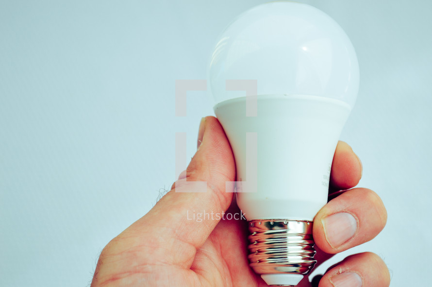 a person holding a lightbulb 