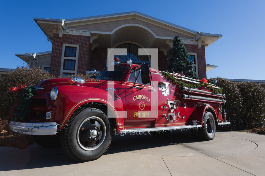 Refurbished vintage red fire truck decorated for Christmas
