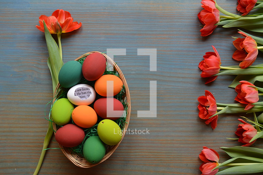 red tulips and a basket of Easter Eggs 