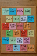 colorful notepads with new year's resolutions for christian life on a corkboard