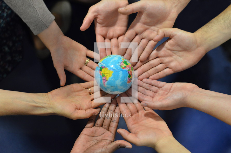 international group holding a globe together. \