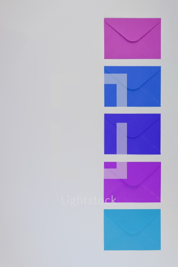 blue, purple, and fuchsia envelopes 