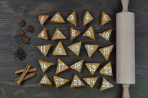 advent cookies on gray wood with rolling pin and spices 